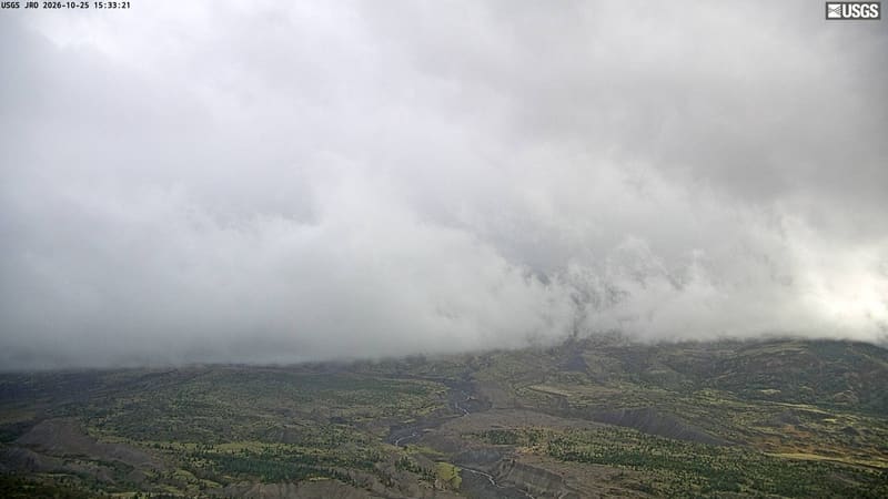 Mount St. Helens rises beyond the valley of the blast zone, its slopes greening and bare by turns.